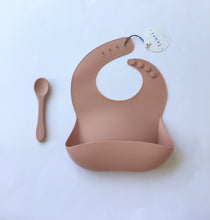 Load image into Gallery viewer, Silicone Baby Bib with pouch, BPA free, non-toxic, earthy natural colours and tones, cream, nude colour, terracotta Lauri Australia with silicone baby spoon
